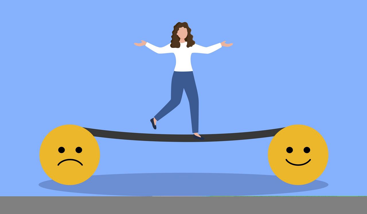 Frau balanciert auf einer Waage mit traurigem und lachendem Smiley