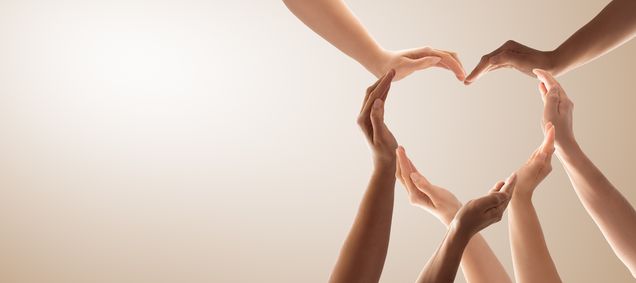 mehrere Hände formen ein Herz