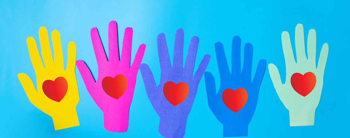 Zeichnung von farbigen Händen, die alle ein rotes Herz in der Handinnenfläche aufweisen